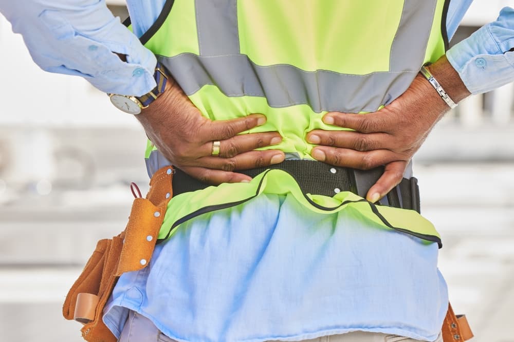 Man, architect and hands in back pain, accident or posture after construction injury on site.