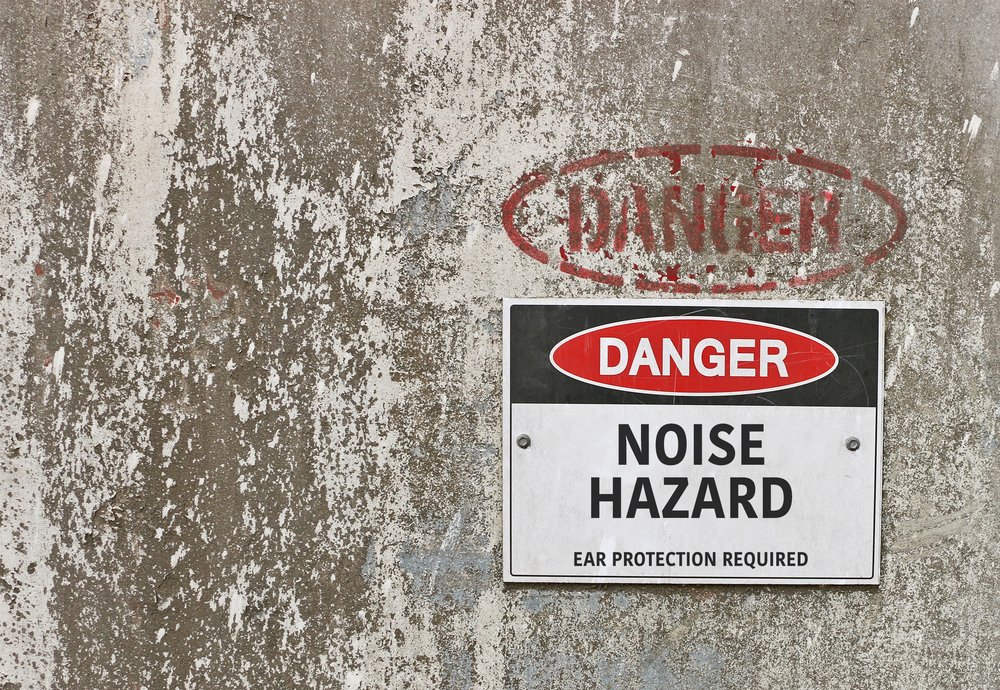 Danger sign warning of workplace noise hazard and required ear protection